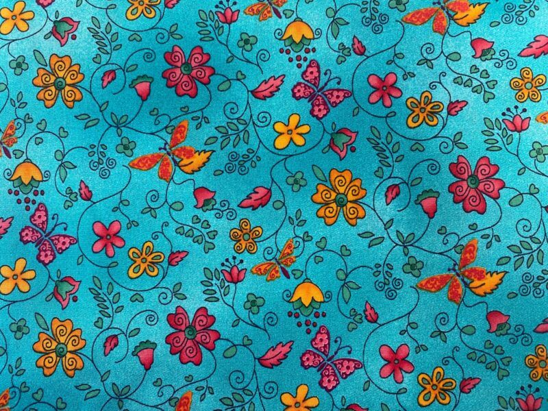 Poplin - blomster og sommerfugle på blå bund